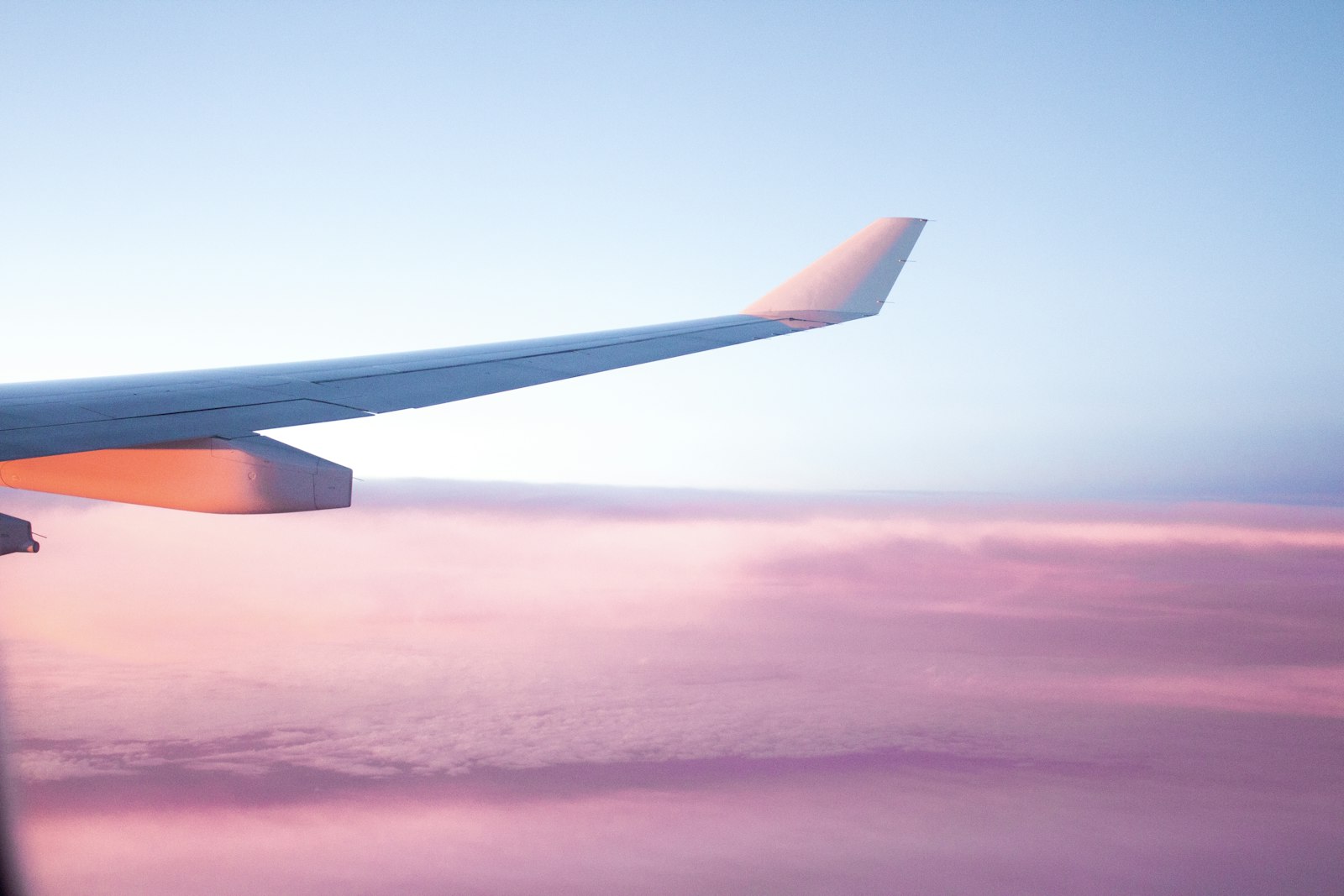 Aircraft wing against a sunset sky